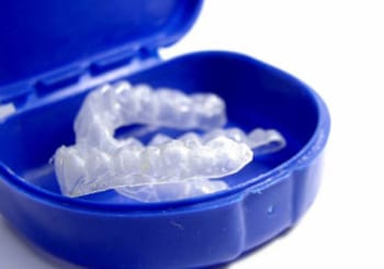 Custom teeth whitening trays in a blue case