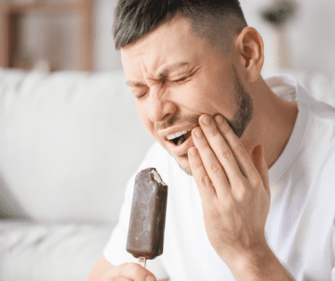 Man Holding Mouth in Pain.