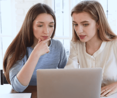 Two Women Looking at Laptop