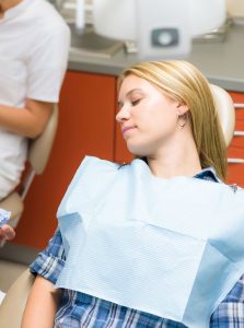 Woman resting in the dental chair while using dental sedation